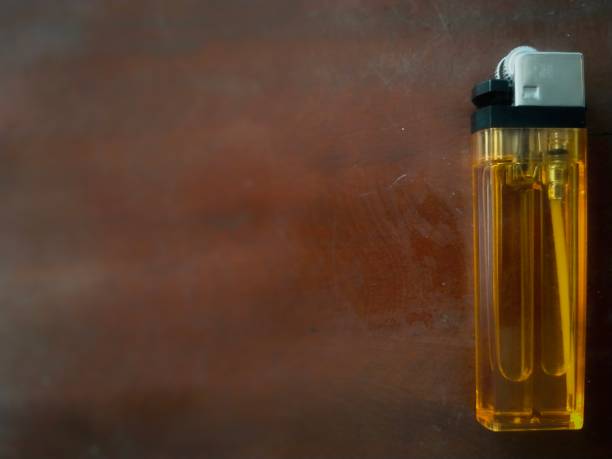 istock Yellow gas lighter on a dark background 1502709213