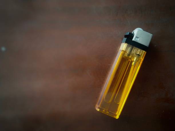 istock Yellow gas lighter on a dark background 1502709219