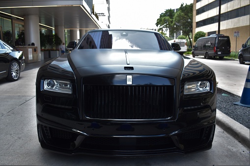 Houston, TX USA June 26, 2023 - Portrait of a black Rolls Royce Wraith coupe in downtown Houston