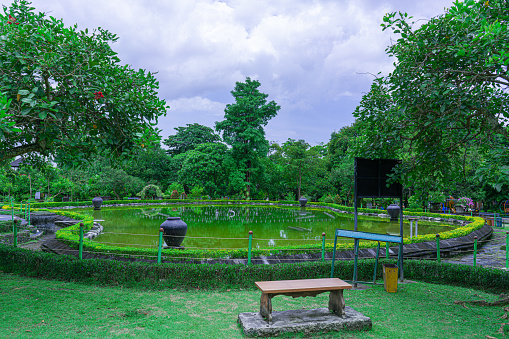 View of a water park pool in the middle of a green urban forest in Denpasar.