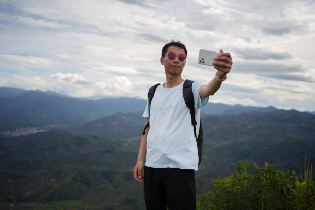 istock Man taking selfie with smartphone on top of mountain 1502730751