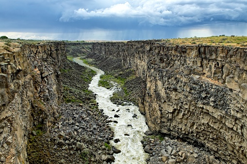 The Malad River winds through the famous Malad Gorge under a dramatic sky in southern Idaho.