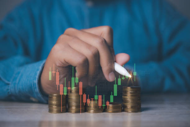 istock Businessman stacking coins with screen forex trading graph financial data. Goal business profit graph development. Stock market, financial growth report. 1502744432