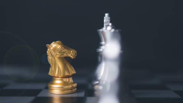 istock Golden horse chess encounters. Chess board game, business competitive. 1502744444