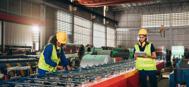 istock Industrial worker inspecting and check up machine at factory machines.Technician working in metal sheet at industry. Foreman checking Material or Machine. 1502756083