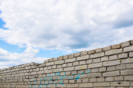 White brick wall and cloudy sky