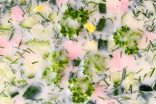 Texture of okroshka with greens close-up. Traditional summer food.