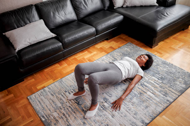 Woman practicing yoga, Glute Bridge exercise, dvi pada pithasana pose