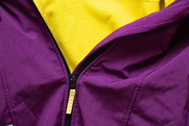 zipper on purple jacket as background close up