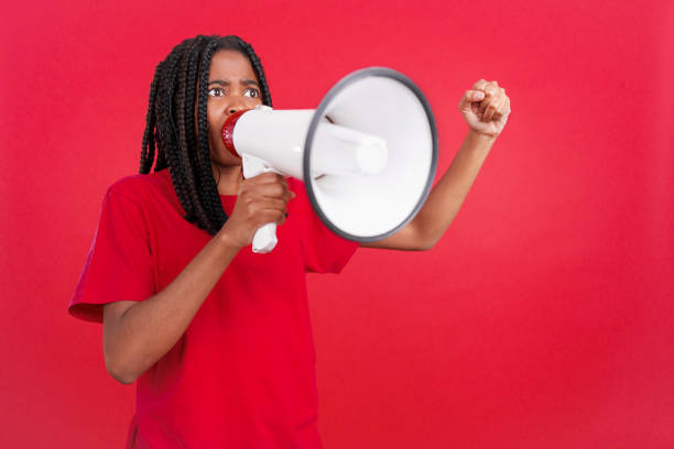 istock Upset african woman yelling using a loudspeaker 1502767742