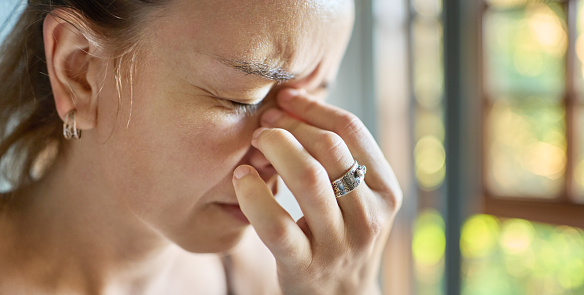 Close-up of a woman at home suffering from severe headache