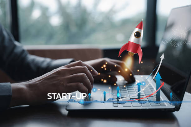 istock Business startup concept with a rocket icon launching from a laptop 1502770338