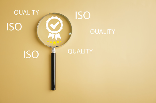 Magnifying glass with five-star and quality warranty icon represents quality assurance, ISO certification, and standardization concept. Symbolizing excellence and customer satisfaction.