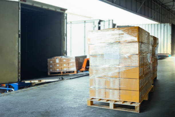 istock Package Boxes Wrapped Plastic Stacked on Pallets. Loading Truck at Warehouse Dock, Cargo Container, Distribution Supplies Shipping, Supply Chain, Shipment. Freight Truck Logistic Cargo Transport. 1502770658
