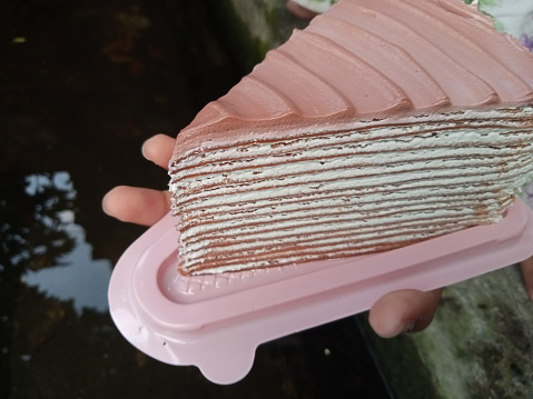 slice cake on hand, pink cake