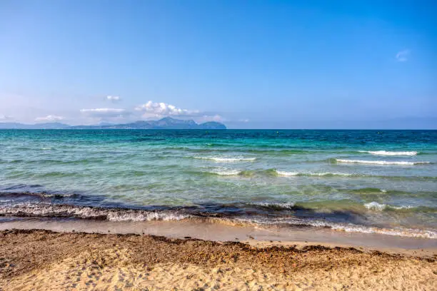 Photo of Sandy natural beach in city Can Picafort. Balearic Islands Mallorca Spain.