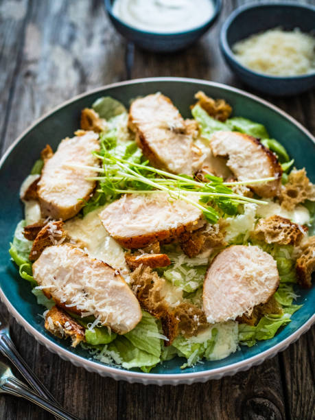 istock Caesar salad  - vegetable salad with roast chicken breast on wooden table 1502777755