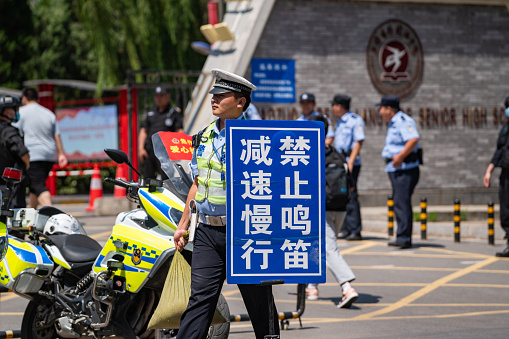 June 7, 2023 Jiaozuo City, Henan Province, China, candidates and parents outside the college entrance examination room, as well as traffic security measures.