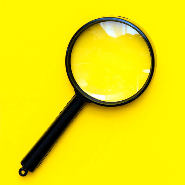 istock Black magnifier on a yellow  background. 1502778321