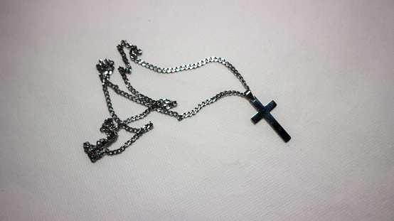 Cross necklace on a white background