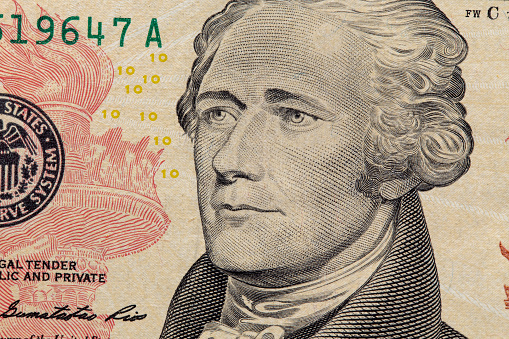 Close up of a ten dollar bill. Background of dollar bills. American Dollars Cash Money. Alexander Hamilton portrait