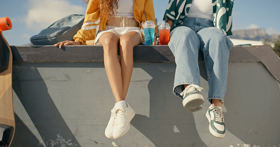 Relax, shoes and summer with friends at skate park for bonding, calm and hipster. Cheers, mockup and teenager with closeup of people in outdoors for skating, fitness and sports training together