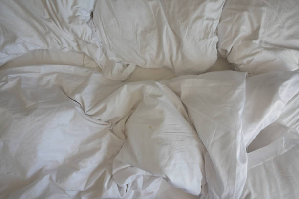 istock messy bed in early morning , messy bed after waking up 1502789149