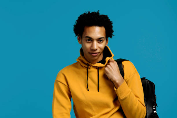 istock student with backpack, young adult with afro hairstyle looking at camera 1502790443