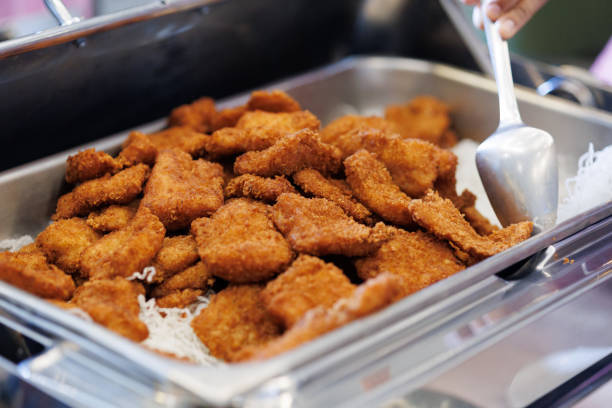 A warm buffet tray holds a pile of freshly deep-fried chicken nugget