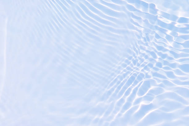 istock Blue water with ripples on the surface. Defocus blurred transparent blue colored clear calm water surface texture with splashes and bubbles. Water waves with shining pattern texture background. 1502798072
