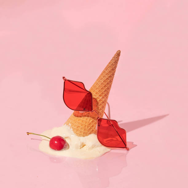 istock Summer creative layout with ice cream cone up side down with vanilla ice cream scoop with bright red cherry and red lips sunglasses on pastel pink background. 80s or 90s retro aesthetic idea. Minimal summer fashion girl idea. 1502798185