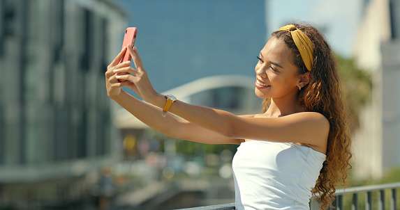 Selfie, social media and woman in city for post, internet update and online mobile app. Travel, emoji and happy female person take picture in town for memory or influencer blog on weekend