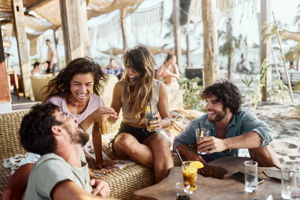 istock Cheerful couples talking during summer day in a beach bar. 1502801807