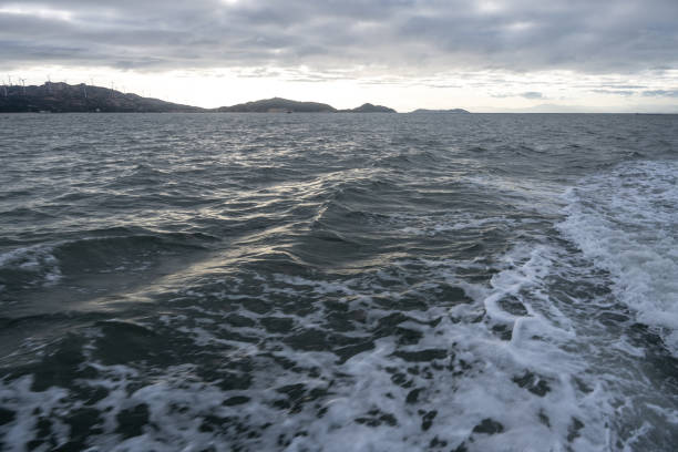 istock At dusk, a passenger ship sailed on the blue waves. 1502802151