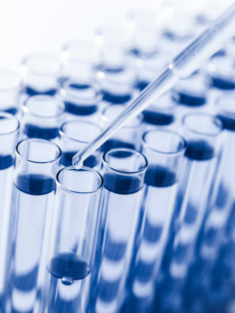 istock Droplet Falling from Pipette into Test Tube. 1502802329
