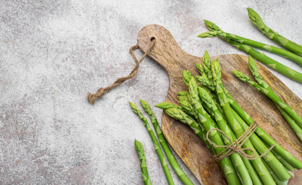 istock Fresh green asparagus on  concrete background. 1502802365
