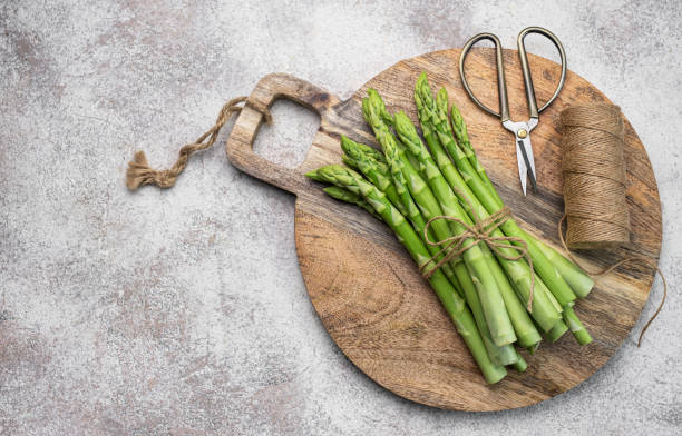 istock Fresh green asparagus on  concrete background. 1502802368