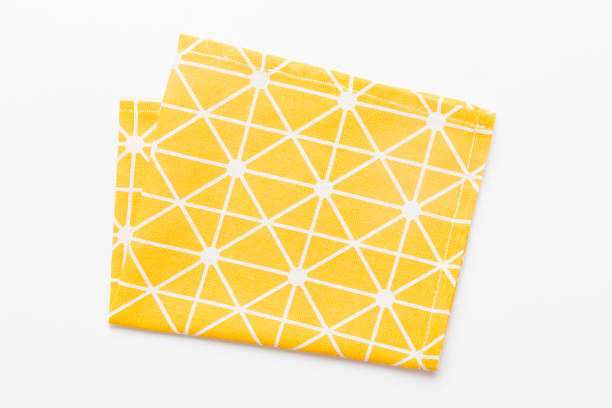 istock top view with yellow empty kitchen napkin isolated on table background. Folded cloth for mockup with copy space, Flat lay. Minimal style 1502817818