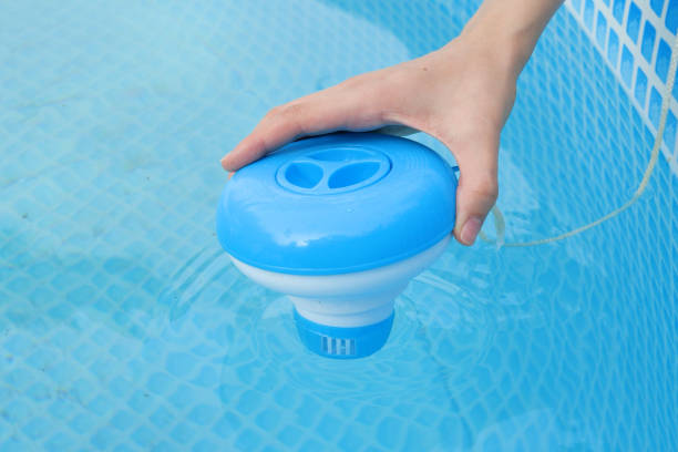 istock Worker hands isinfection and chlorination of water in the pool. Purification from pollution pool chlor dispenser 1502817825