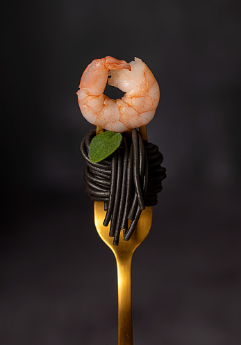 Macro food photography of  black spaghetti, pasta, shrimp, prawn