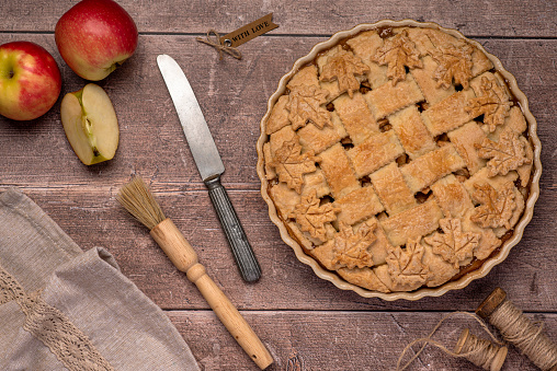 Food photography of apple pie, pastry, dessert, knife, towel, brush, rustic