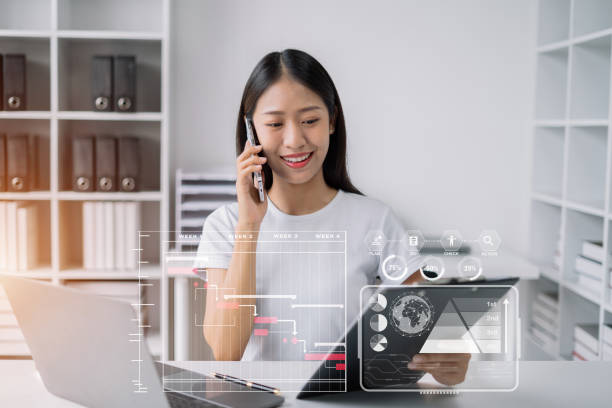 istock Businesswoman hand Project manager working and update tasks and Gantt chart scheduling virtual diagram.with smart phone, tablet and laptop in office. 1502831274