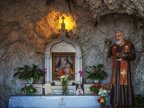 A Christian shrine with a picture of the Virgin Mary in a cave at the entrance of Castelmola in Sicily Italy