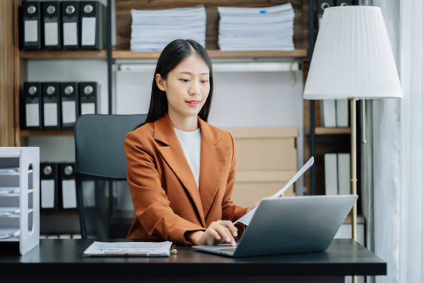 istock Businesswoman hand Project manager working and update tasks and Gantt chart scheduling with smart phone, tablet and laptop in office. 1502838179