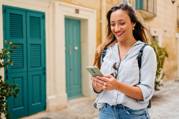 istock Young Woman Using Smart Phone On The Street In Valletta 1502841981