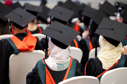 A close-up rear view shot of graduation hats during a successful commencement ceremony for university graduates.