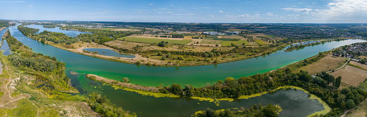 Meuse river panorama during a dry summer seen from above near Visé in Belgium and Maastricht in The Netherlands. The border between Belgium and The Netherlands follows the river where the foreground is Belgium and the other side is Netherlands.