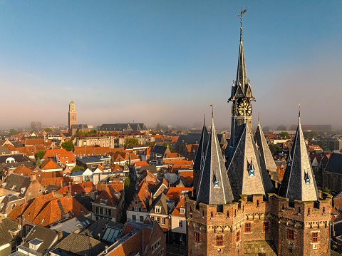 View on the Sassenpoort in the city of Zwolle, Overijssel, The Netherlands during a beautiful summer morning with a hazy fog over the city seen from above.