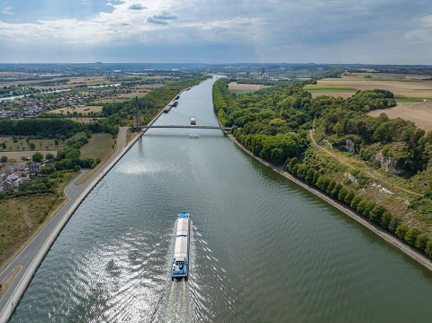 Freight ships at the Lanaye locks where the Albert Canal connects to the river Meuse close to Liege and Maastricht. Drone point of view.
