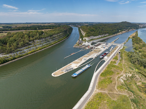 Freight ships in the Lanaye locks where the Albert Canal connects to the river Meuse close to Liege and Maastricht. Drone point of view.